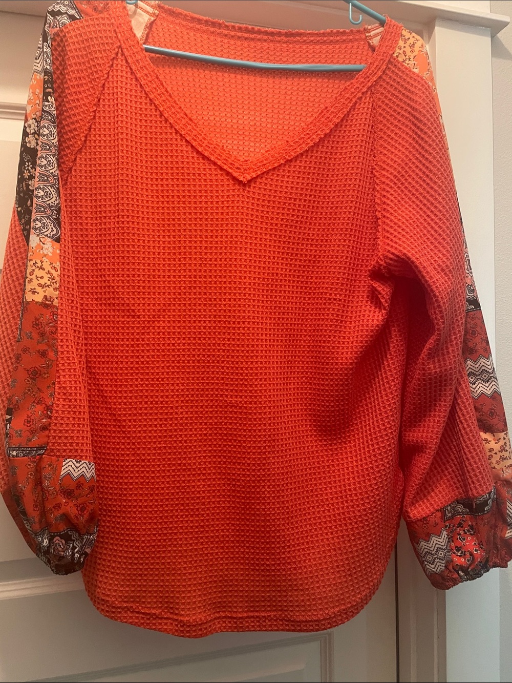 Women's Orange Waffle Knit V-Neck Blouse with Patterned Sleeve Panels